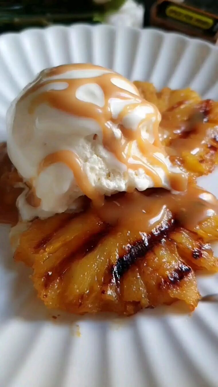 Grilled Pineapple Served With Vanilla Icecream And Butterscotch Sauce