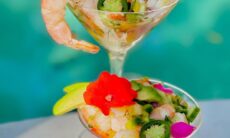 Shrimp & Mango Ceviche Served In A Martini Glass With Cucumber & Tri-color Peppers